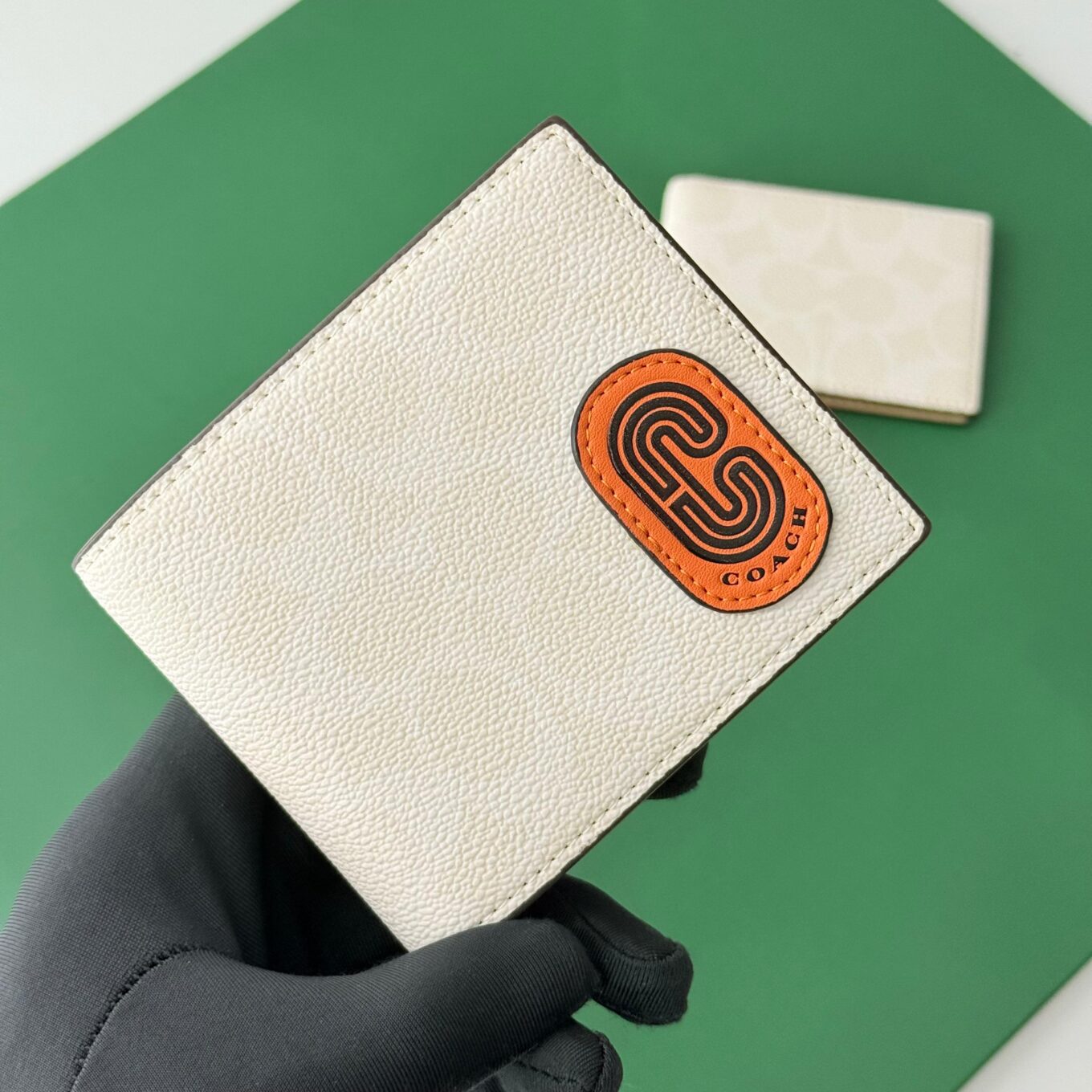 WhatsApp Image 2025-09-29 at 5.46.38 PM Coach White Canvas Orange Patch Men’s Wallet With Card Holder